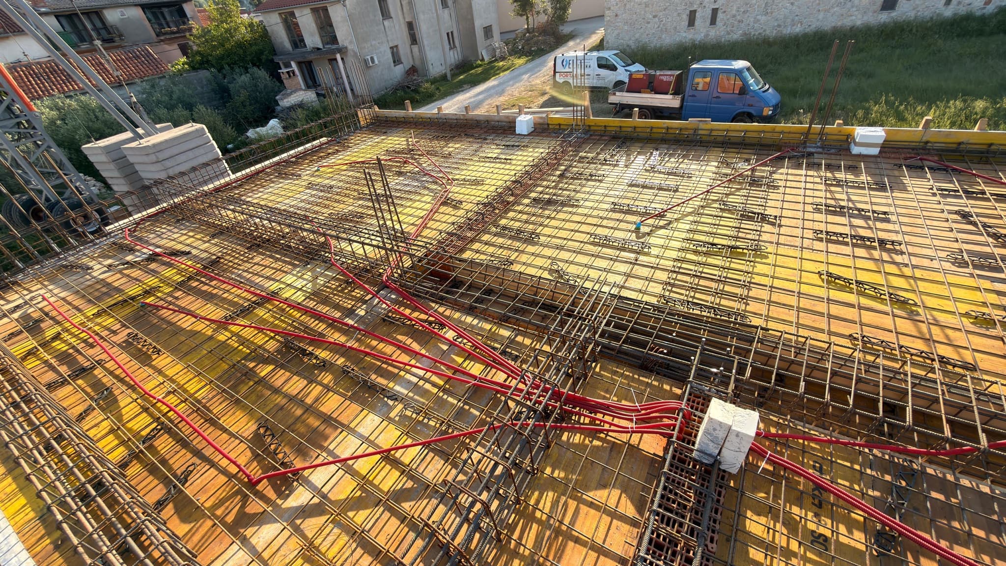 Cable runs and lighting boxes set into the slab reinforcement of a new build.