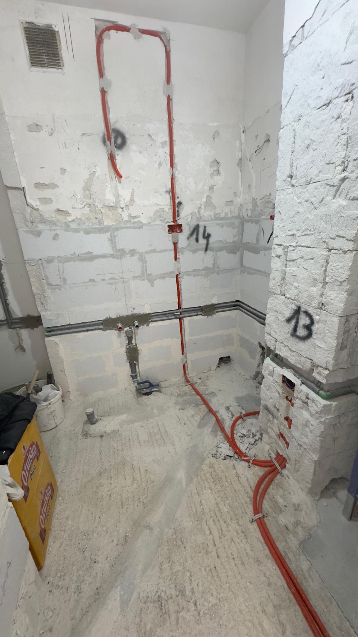 Electrical and plumbing services prepared in a bathroom before finishing work.