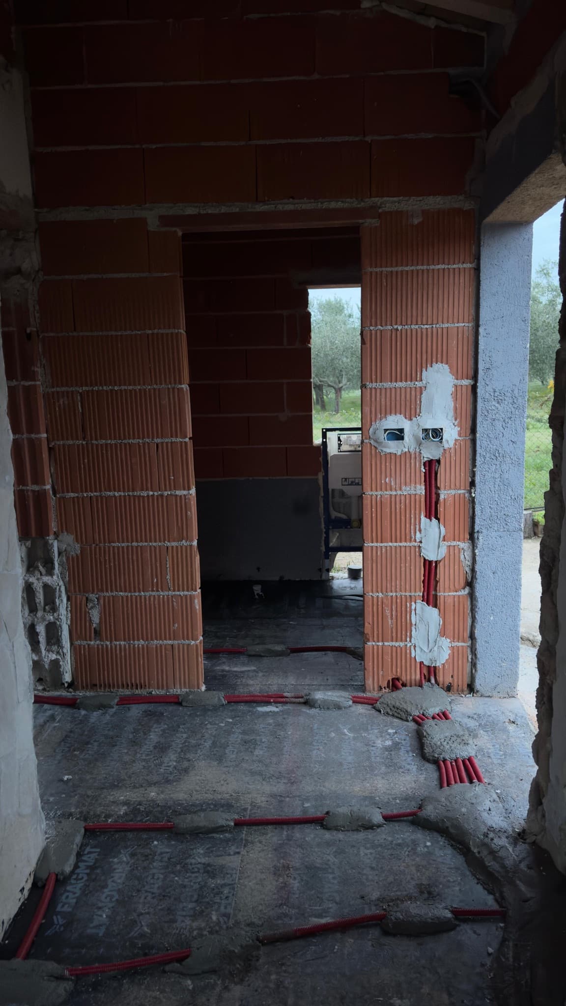 Conduit runs and back boxes in the walls of a new build at first-fix stage.