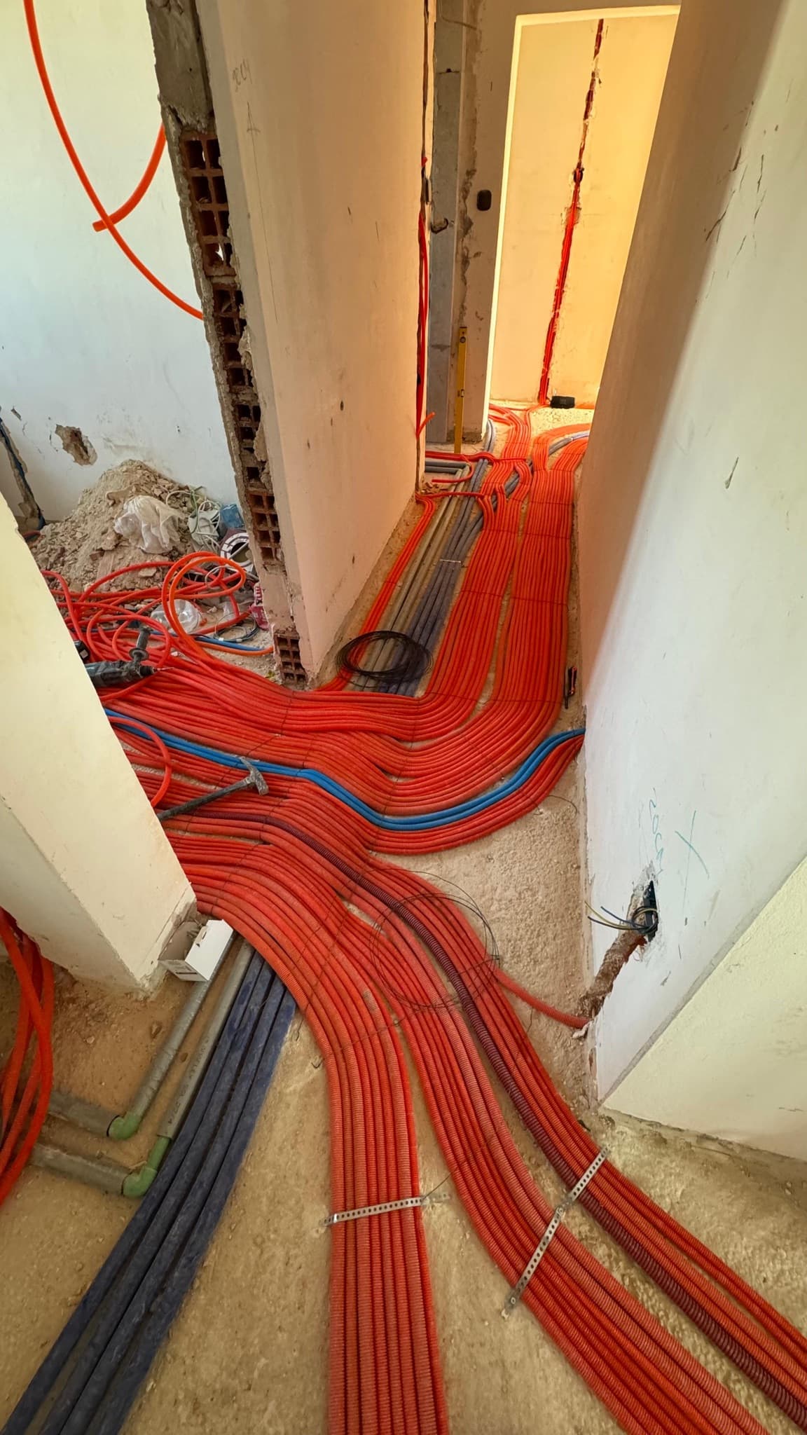 A dense bundle of conduits running towards the switchboard.