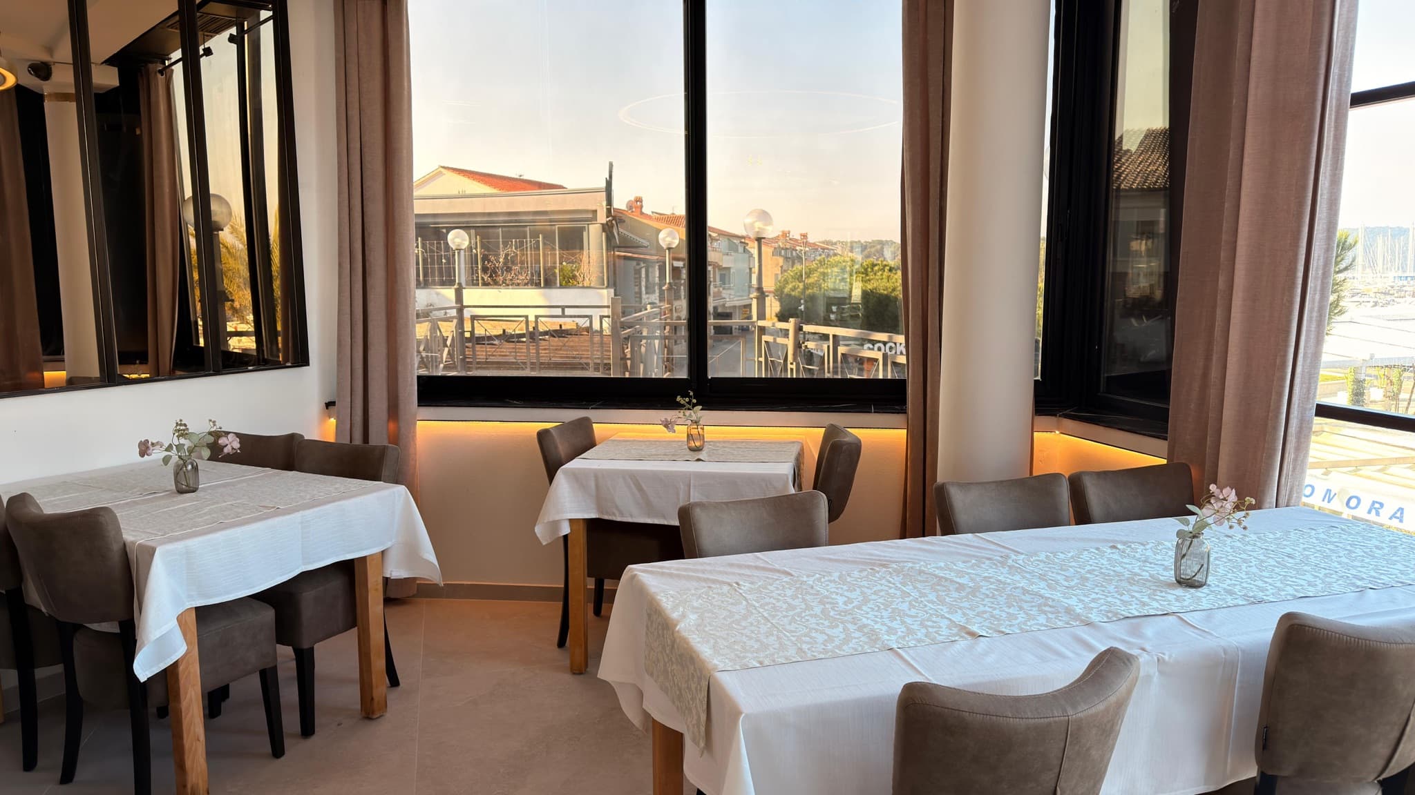 Concealed lighting along the window ledge in a dining area.